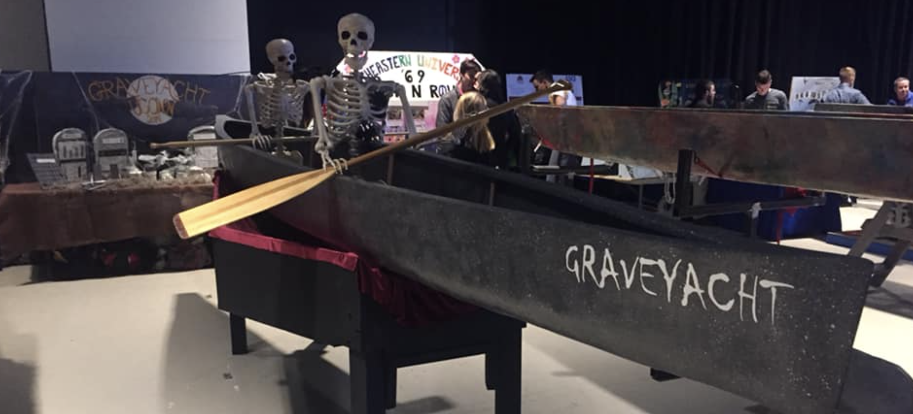 the graveyacht displayed at competition with a skeleton sitting in it with a paddle